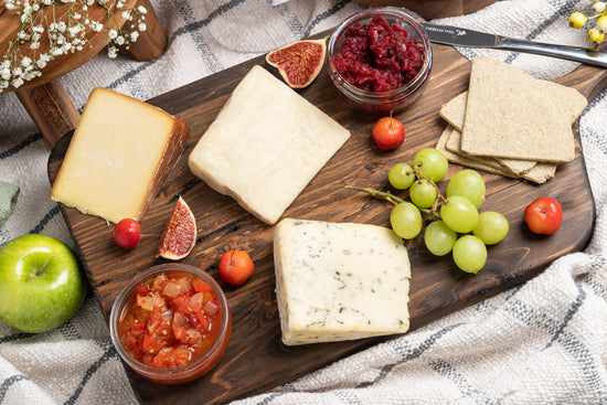 Local cheese platter with grapes, chutney and apples